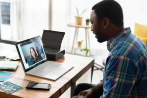 person having a virtual meeting on laptop