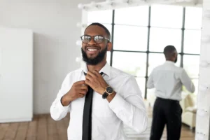 smiling-african-american-businessman-adjusting-tie