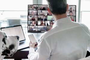 man-working-remotely-multitasking-video-chatting-2022-11-14-06-39-49-utc