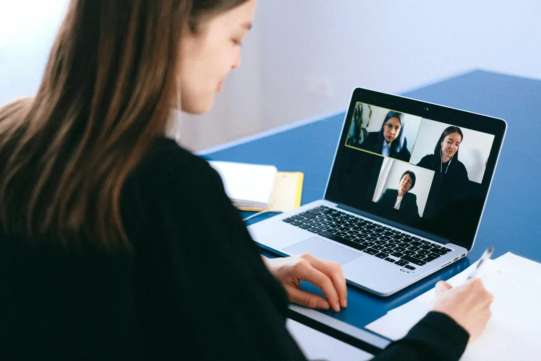 Person attending a video meeting on a laptop