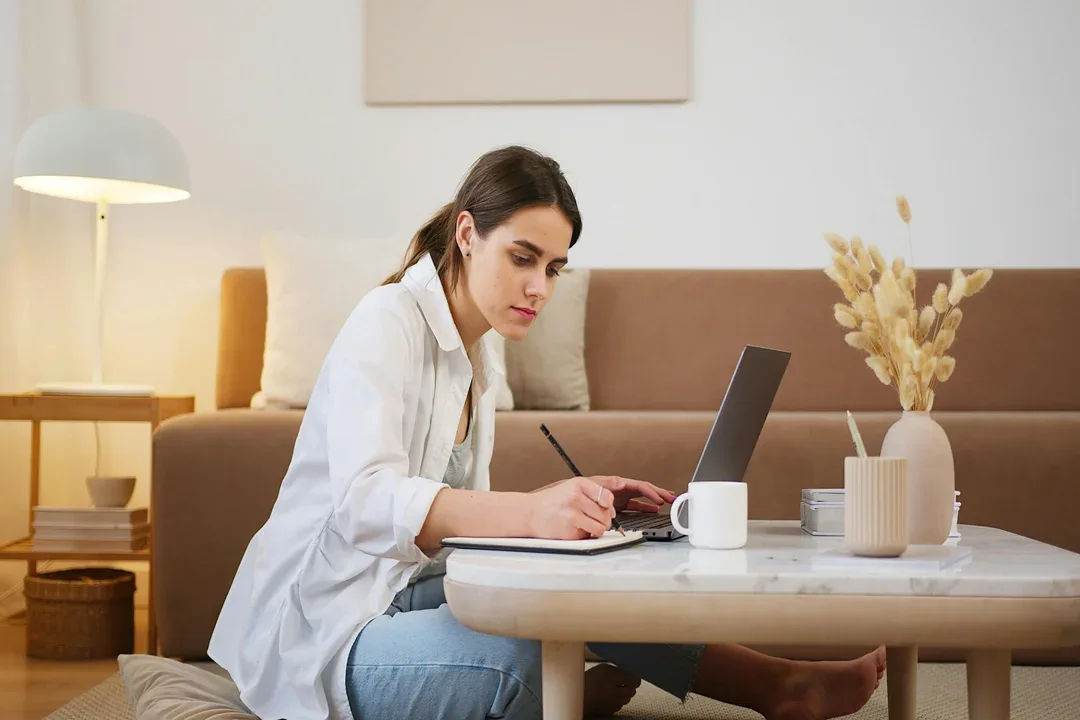 Woman working at a laptop at home