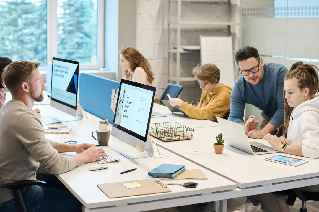 Colleagues working at computers in an open office
