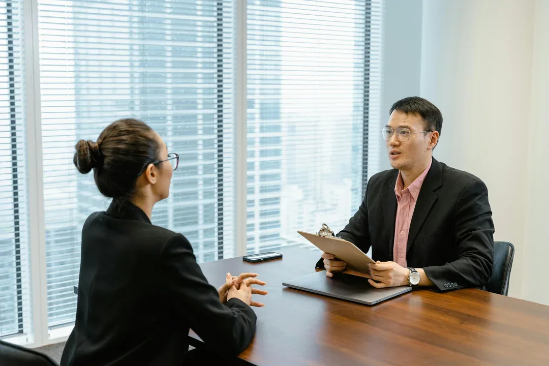 Candidate meeting an interviewer across a desk