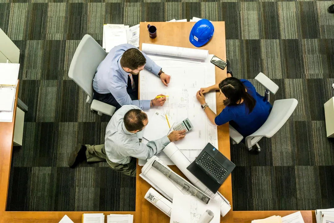 Overhead view of an engineering team reviewing plans
