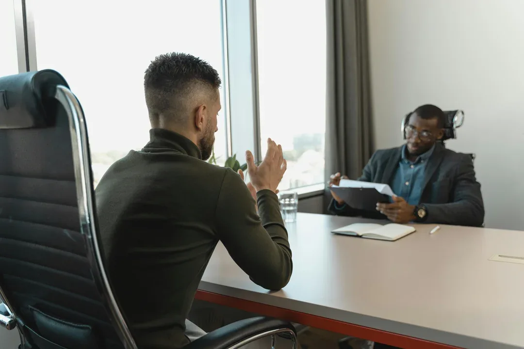 Candidate talking with an interviewer across a desk