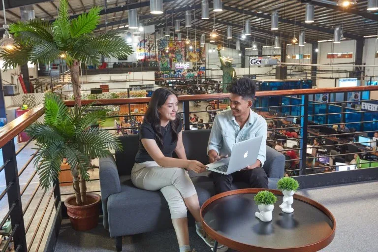 Two colleagues reviewing work together in a Clark Outsourcing lounge