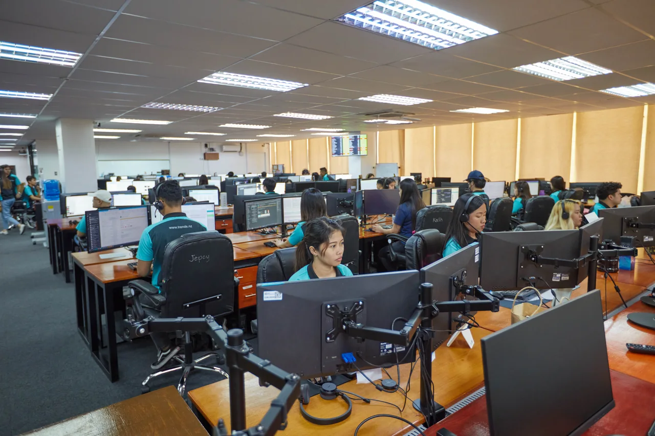 Medical Virtual Assistant outsourcing in the Philippines — colleagues working at desktop computers in an open-plan office