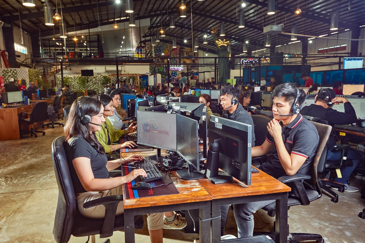 Technical Support Representative outsourcing in the Philippines — headset-wearing colleagues seated at facing computer desks