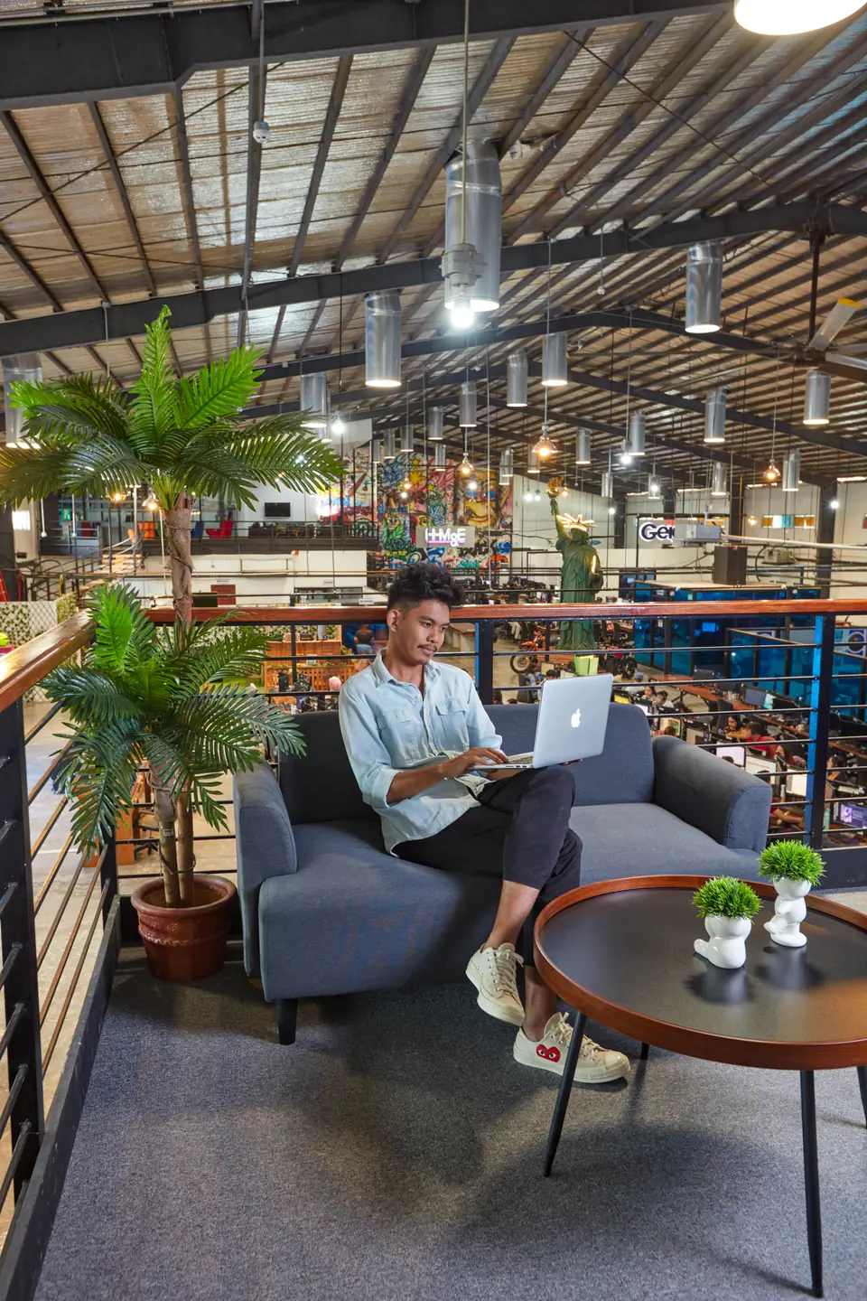 Virtual assistant outsourcing in the Philippines, shown with laptop work at the Clark Outsourcing office
